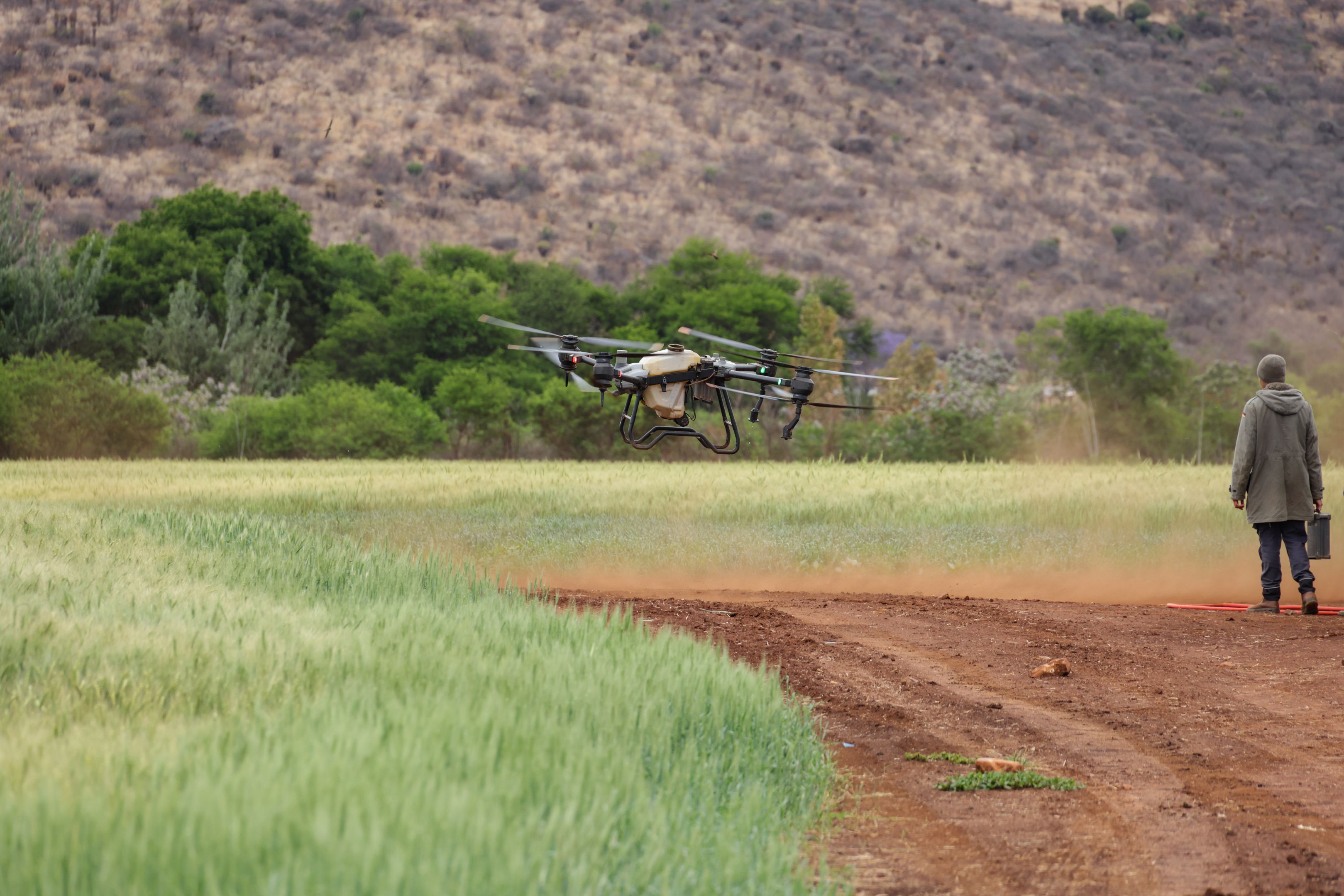 Farmer and drone in field